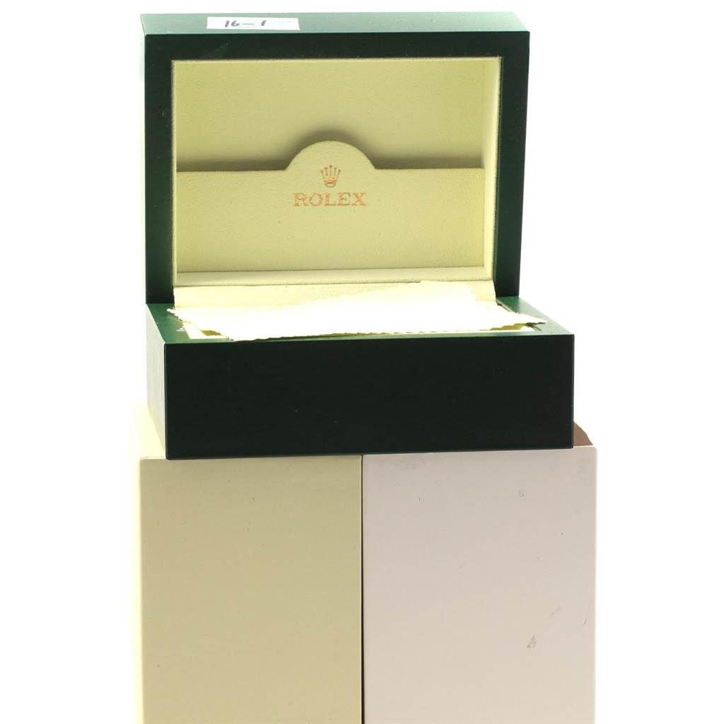 The image shows an open Rolex box for the Submariner model, with the brand logo and name visible inside.