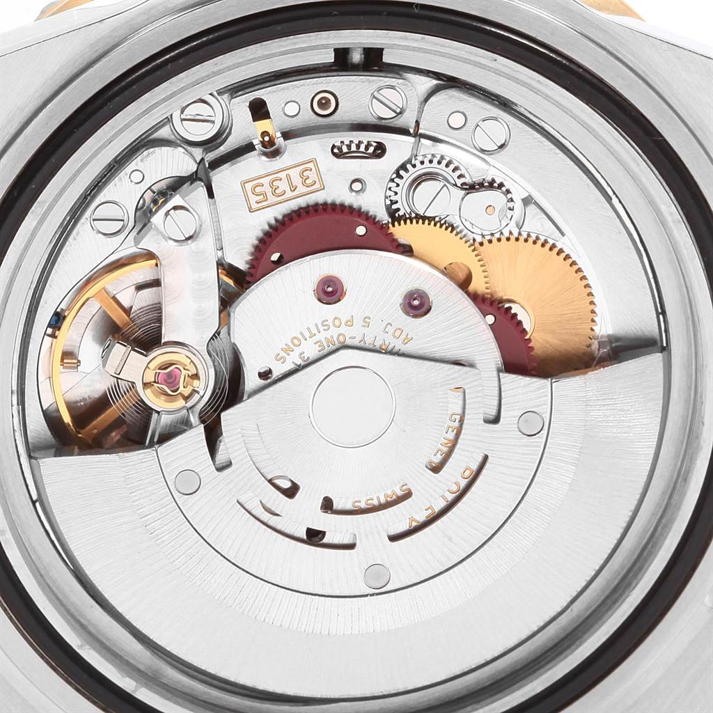 The image shows a close-up view of the intricate internal movement of a Rolex Submariner 16613 Men's Steel and Gold (two tone) Black Dial 16613 Men's Steel and Gold (two tone) Black Dial watch.
