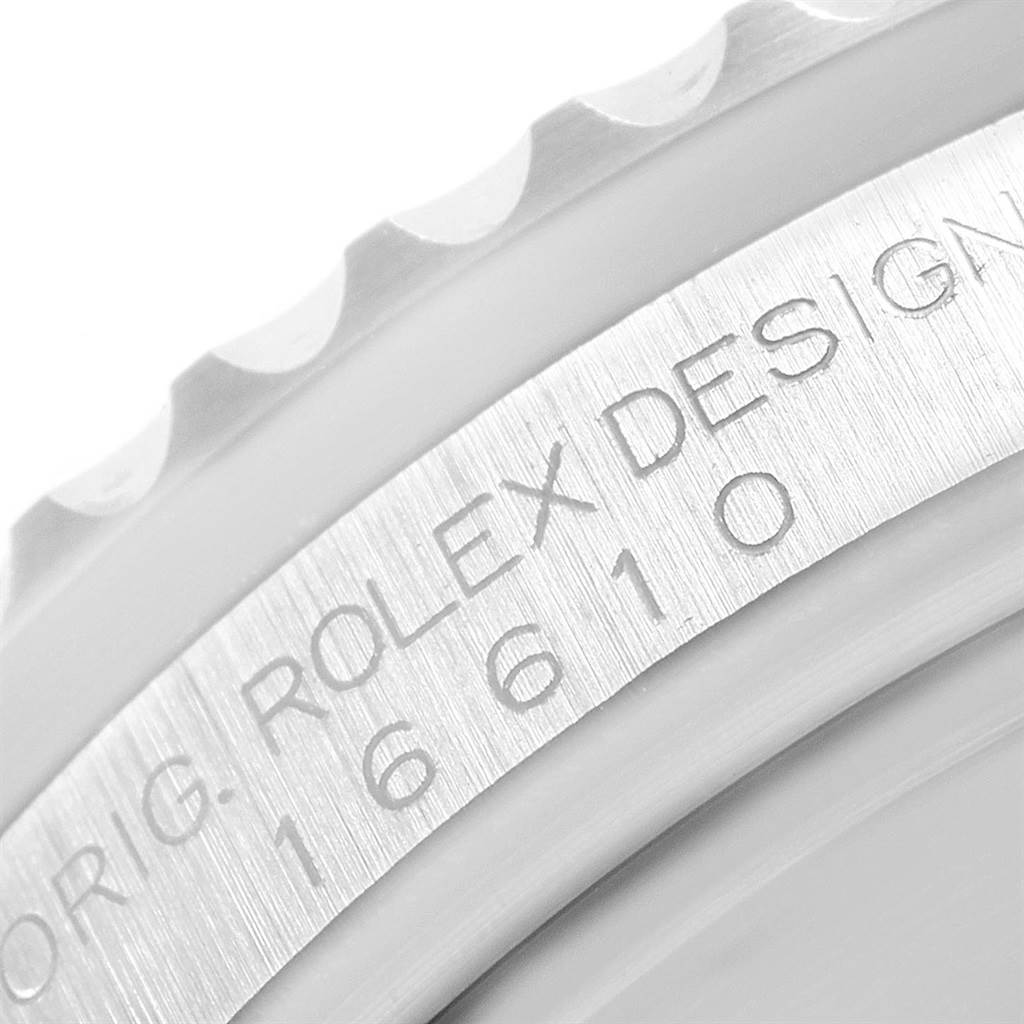 Close-up of the etched design and reference number on the bezel of a Rolex Submariner 16610 Men's Stainless Steel Black Dial 16610 Men's Stainless Steel Black Dial watch.