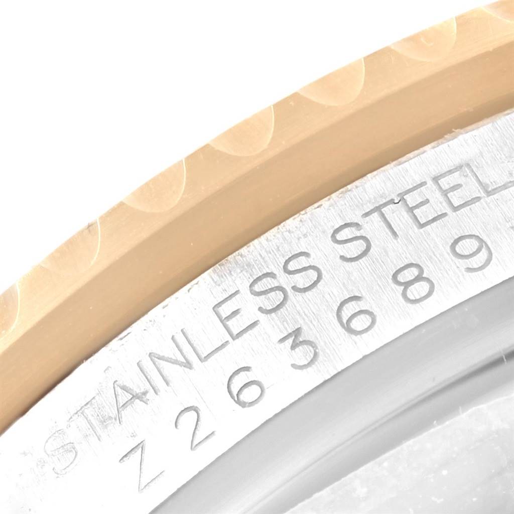 This close-up image features the bezel and part of the case with engraved serial numbers of a Rolex Submariner 16613 Men's Steel and Gold (two tone) Blue Dial 16613 Men's Steel and Gold (two tone) Blue Dial watch.