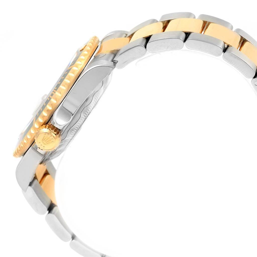 The image shows a side view of a Rolex Submariner 16613 Men's Steel and Gold (two tone) Blue Dial 16613 Men's Steel and Gold (two tone) Blue Dial watch focusing on its bracelet and crown.