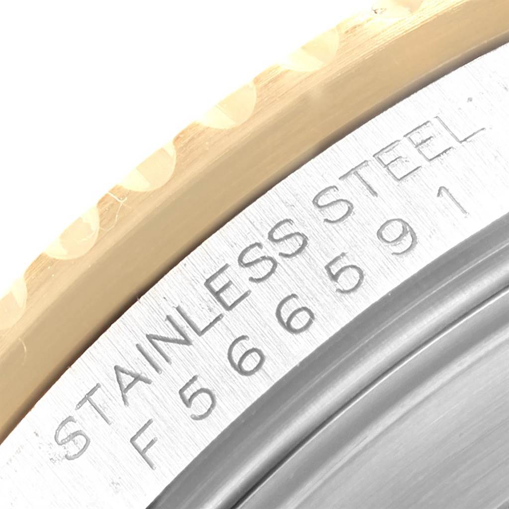 The image shows a close-up of the side of the case on a Rolex Submariner 16613 Men's Steel and Gold (two tone) Black Dial 16613 Men's Steel and Gold (two tone) Black Dial, including the bezel and the engraved serial number.