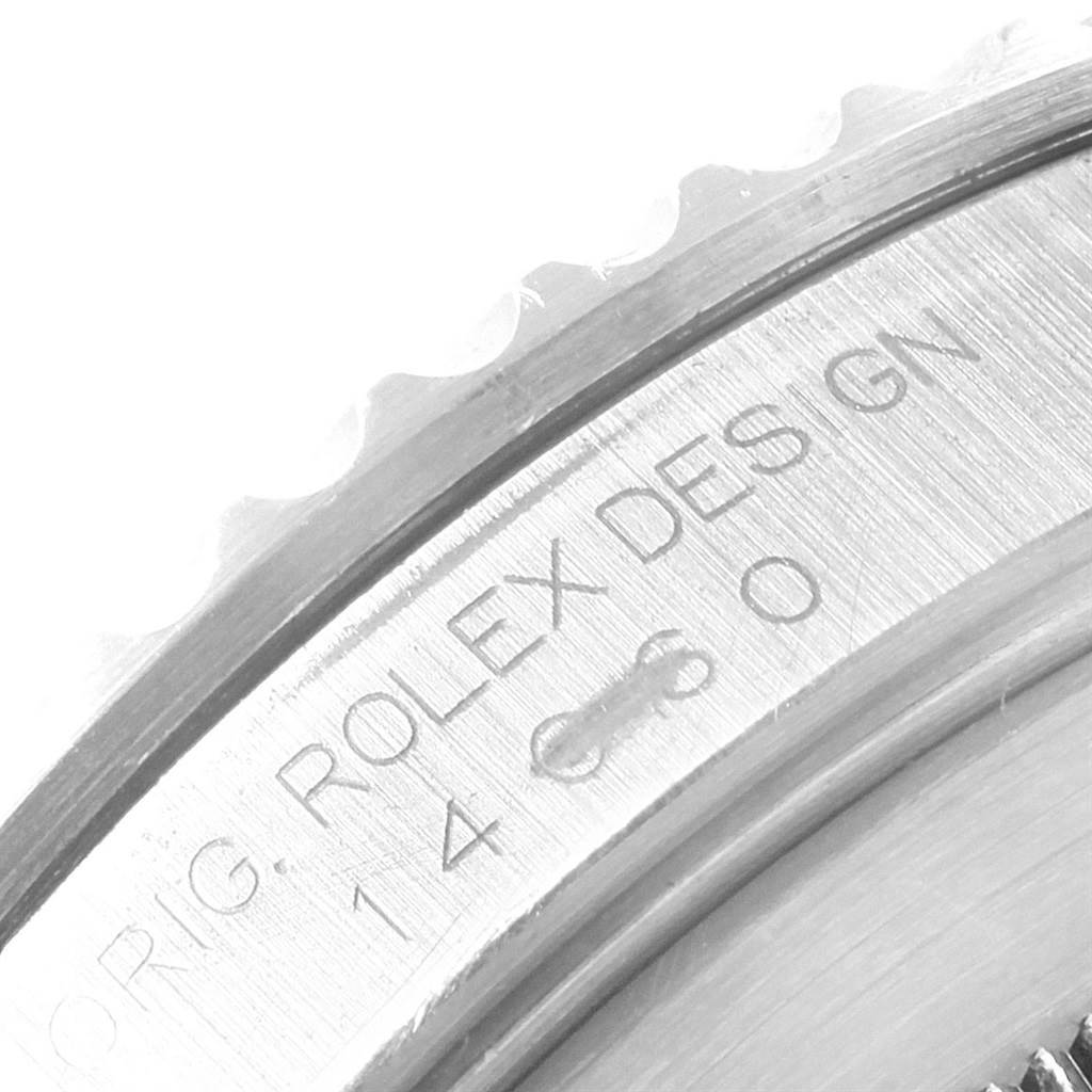 This is a close-up of the side view of a Rolex Submariner 14060 Men's Stainless Steel Black Dial 14060 Men's Stainless Steel Black Dial watch showing the "ROLEX DESIGN" engraving.