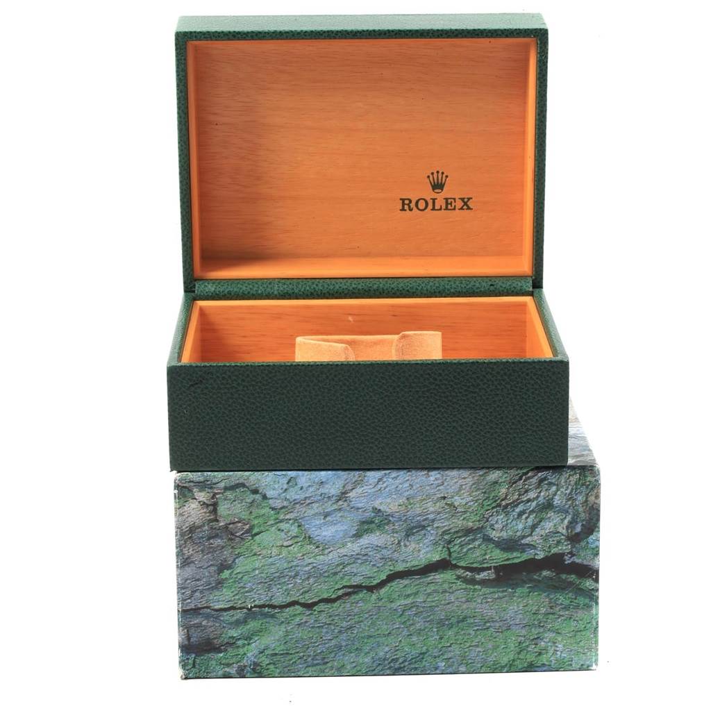 The image shows an open Rolex box, likely used for storing a Submariner model watch, with a visible interior and exterior.
