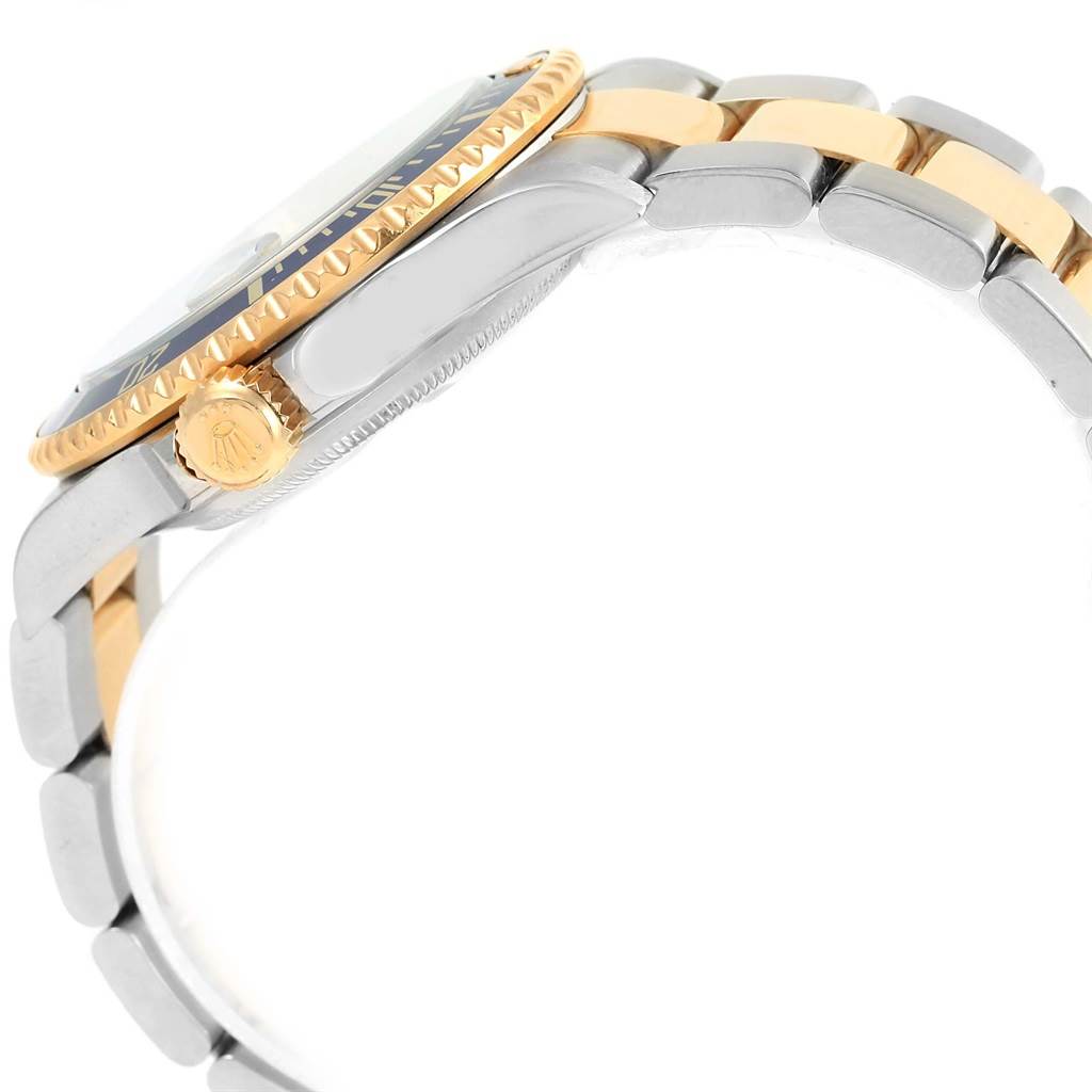 The image shows a side view of a Rolex Submariner 16613 Men's Steel and Gold (two tone) Blue Dial 16613 Men's Steel and Gold (two tone) Blue Dial, highlighting its crown, bezel, and bracelet.