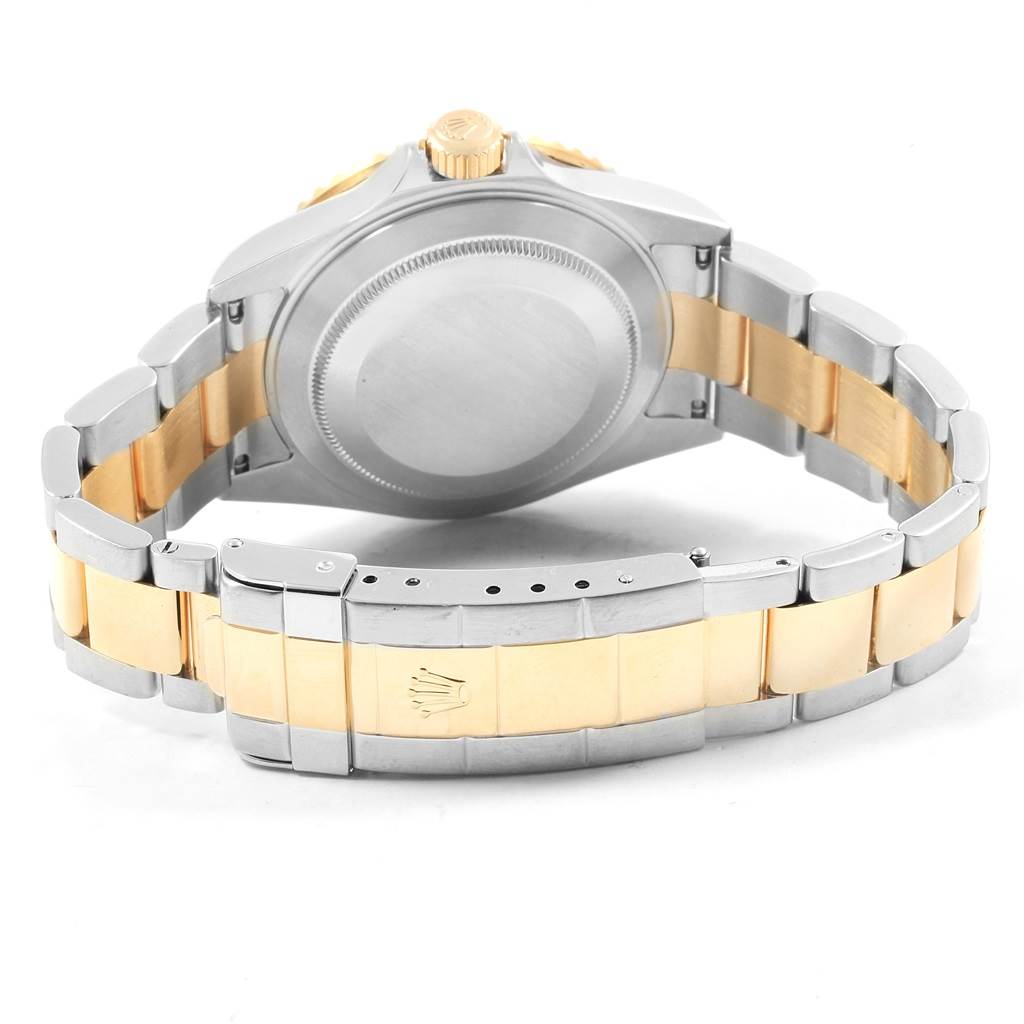 This image shows the back case and bracelet of a Rolex Submariner 16613 Men's Steel and Gold (two tone) Blue Dial 16613 Men's Steel and Gold (two tone) Blue Dial watch in two-tone steel and gold.