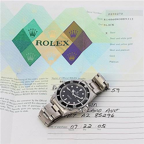 The image shows a Rolex Submariner 14060 Men's Stainless Steel Black Dial 14060 Men's Stainless Steel Black Dial watch at an angle, along with its certificate and paperwork.