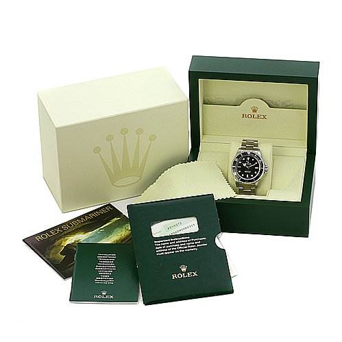 The image shows a Rolex Submariner 14060 Men's Stainless Steel Black Dial 14060 Men's Stainless Steel Black Dial watch at an angle inside a green box, alongside an outer box and accompanying booklets.