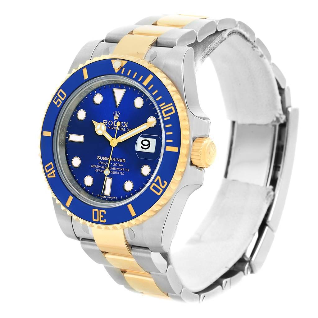 This Rolex Submariner 116613 Men's Steel and Gold (two tone) Blue Dial 116613 Men's Steel and Gold (two tone) Blue Dial watch is shown at a three-quarter angle, displaying its blue dial and bezel, two-tone bracelet, and date window.