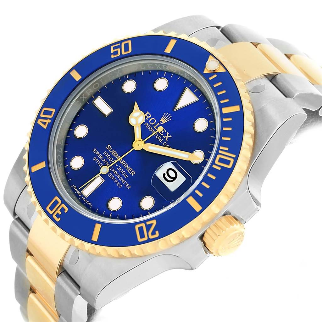 The image shows a Rolex Submariner 116613 Men's Steel and Gold (two tone) Blue Dial 116613 Men's Steel and Gold (two tone) Blue Dial watch at a tilted angle, highlighting its blue and gold bezel, blue dial, and metal strap.