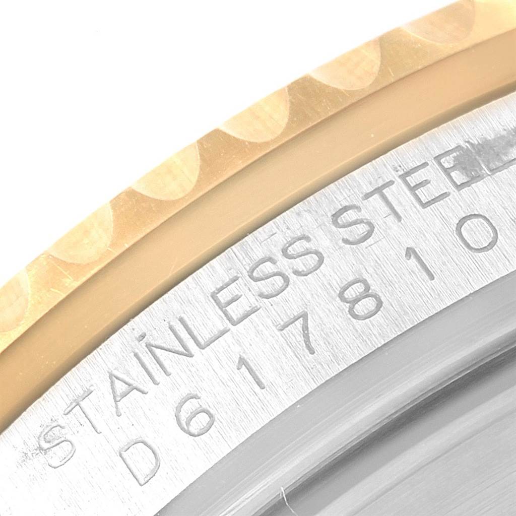 This image shows a close-up of the ring and case back of a Rolex Submariner 16613 Men's Steel and Gold (two tone) Black Dial 16613 Men's Steel and Gold (two tone) Black Dial, highlighting the stainless steel engraving.