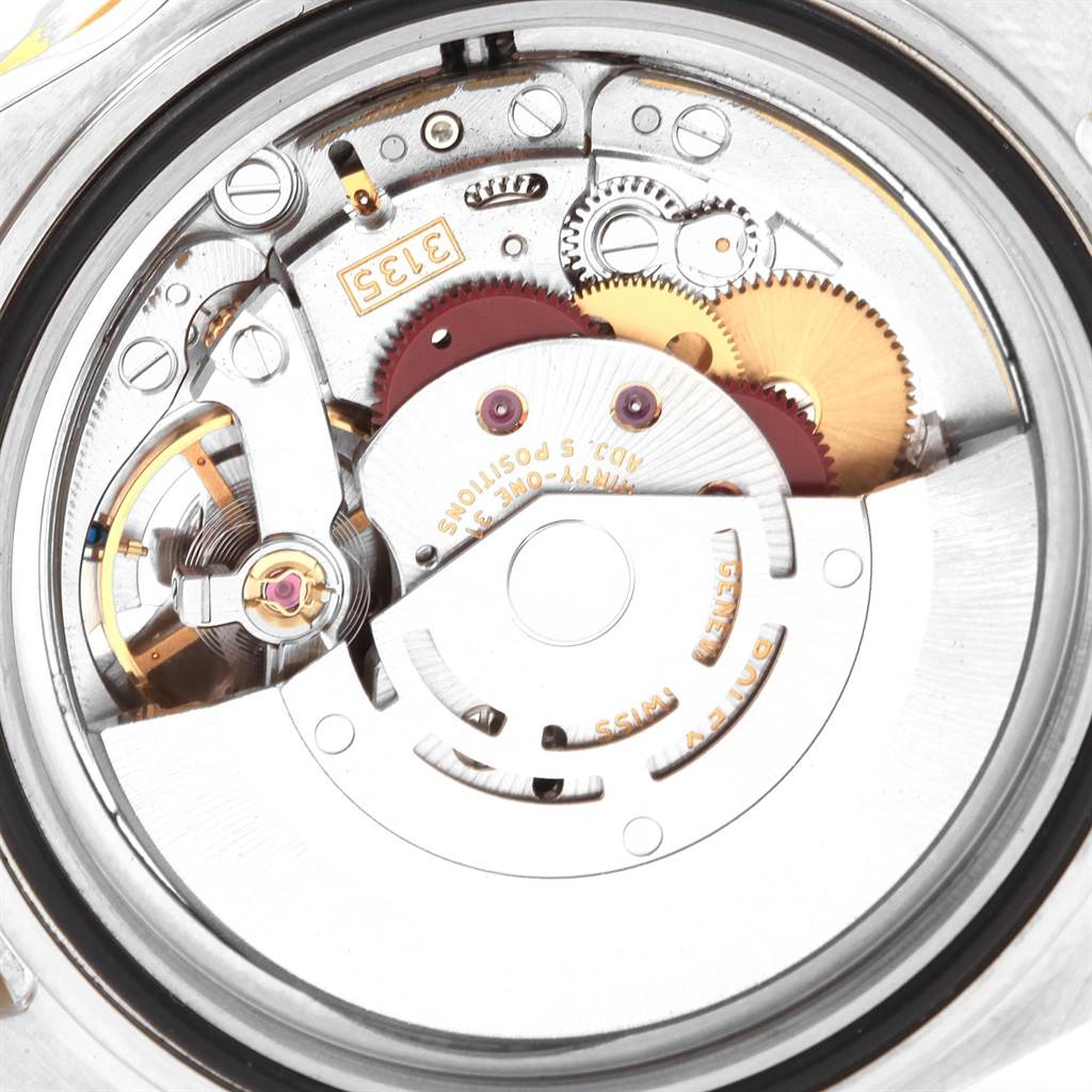 The image shows the internal movement mechanism of a Rolex Submariner 16613 Men's Steel and Gold (two tone) Black Dial 16613 Men's Steel and Gold (two tone) Black Dial watch, showcasing gears and components.