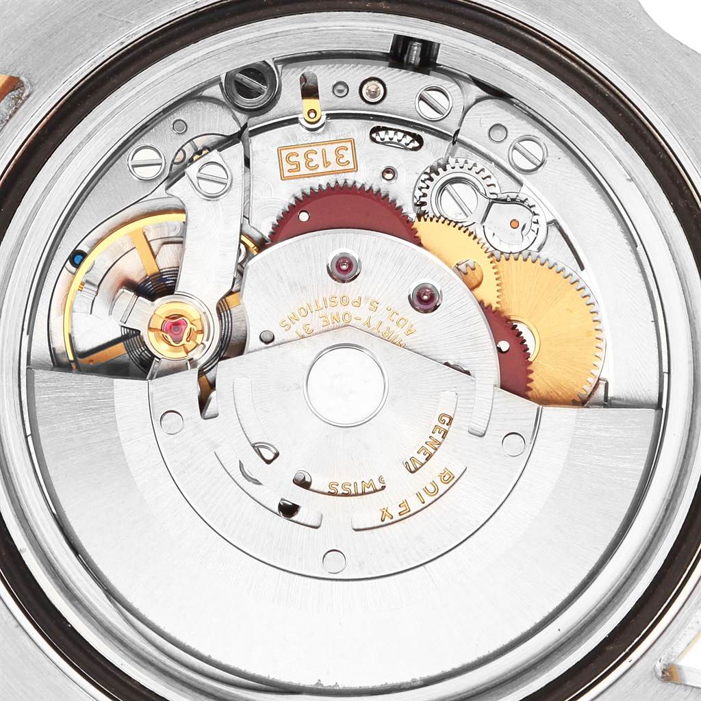 The image shows the internal mechanism of a Rolex Submariner 116613 Men's Steel and Gold (two tone) Black Dial 116613 Men's Steel and Gold (two tone) Black Dial watch, highlighting gears, rotor, and intricate components from a close-up angle.