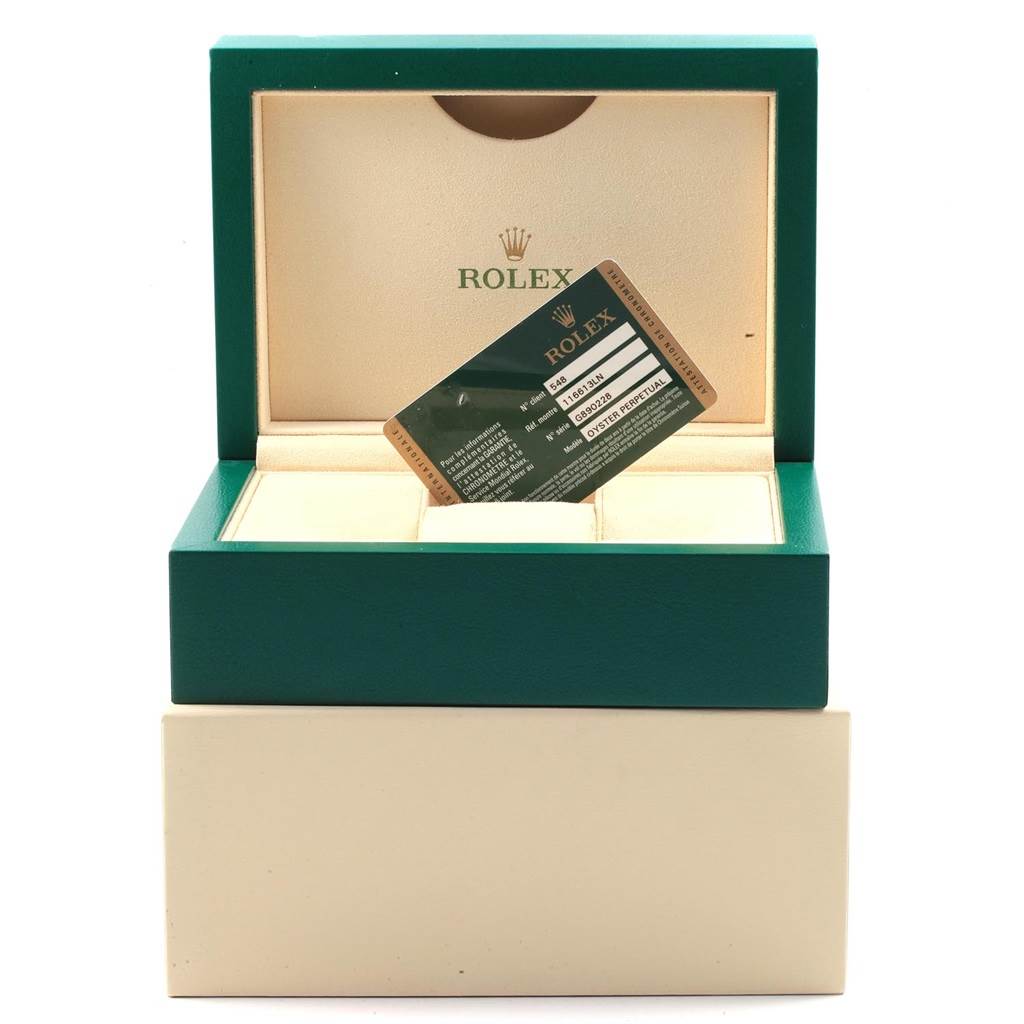 The image shows an open Rolex watch box for the Submariner model with a warranty card inside.