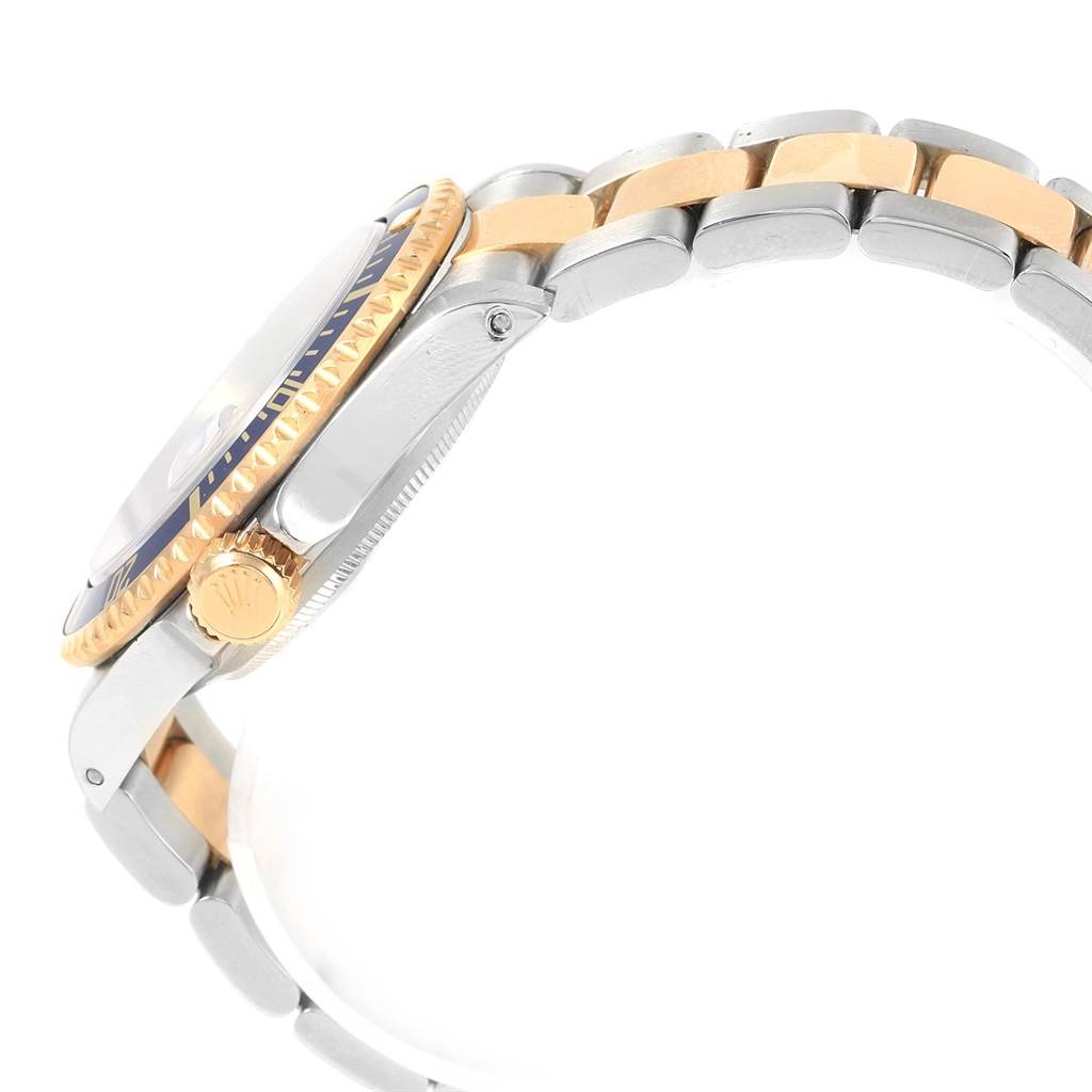 The image shows a side view of a Rolex Submariner 16613 Men's Steel and Gold (two tone) Blue Dial 16613 Men's Steel and Gold (two tone) Blue Dial watch, highlighting the crown, bezel, and part of the two-tone bracelet.