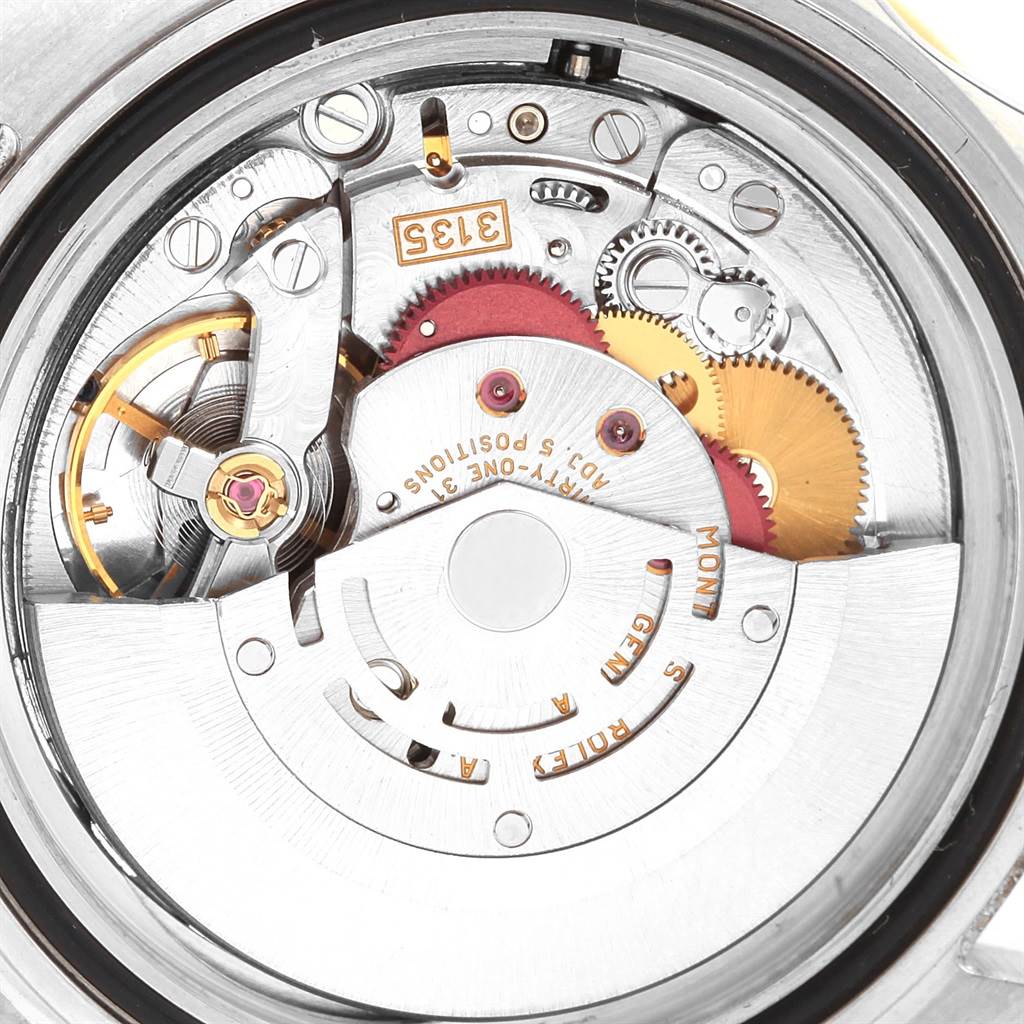 The image shows the inner workings, specifically the movement mechanism, of a Rolex Submariner 16613 Men's Steel and Gold (two tone) Blue Dial 16613 Men's Steel and Gold (two tone) Blue Dial watch from a close-up angle.