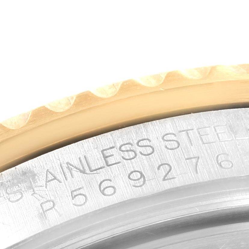 This image shows a close-up of the bezel and part of the case back, displaying the serial number and "STAINLESS STEEL" engraving on the Rolex Submariner 16613 Men's Steel and Gold (two tone) Blue Dial 16613 Men's Steel and Gold (two tone) Blue Dial.