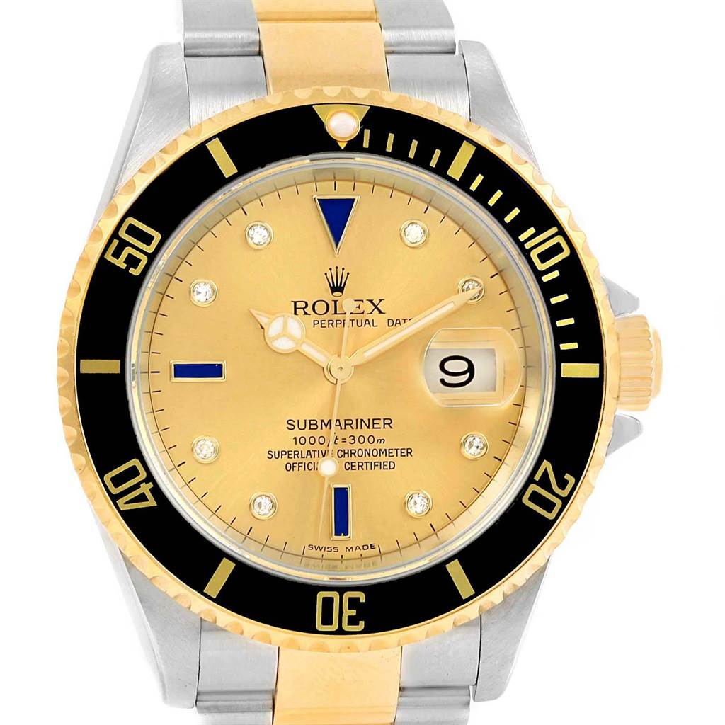The image shows a front view of a Rolex Submariner 16613 Men's Steel and Gold (two tone) Champagne Dial 16613 Men's Steel and Gold (two tone) Champagne Dial watch, highlighting the gold dial, date window, ceramic bezel, and metal bracelet.