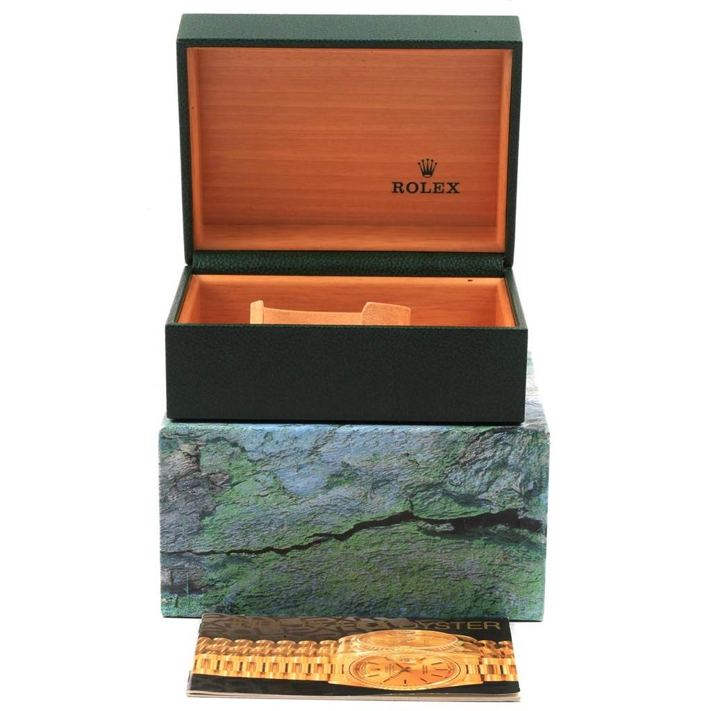 The image shows an open Rolex Submariner 16613 Men's Steel and Gold (two tone) Champagne Dial 16613 Men's Steel and Gold (two tone) Champagne Dial watch box with packaging and a brochure in front.