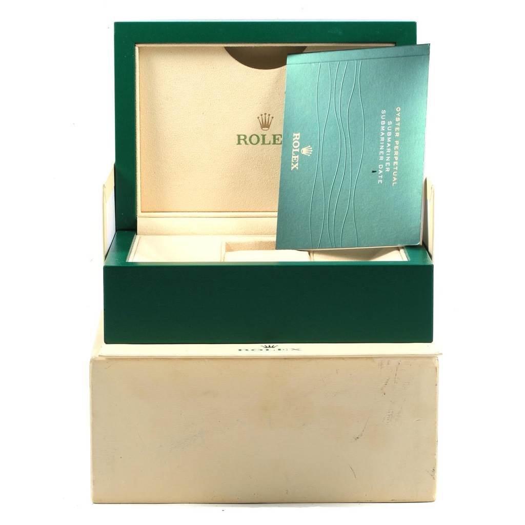 This image shows a green Rolex Submariner 116610LV Men
s Stainless Steel Green Dial 116610LV Men
s Stainless Steel Green Dial watch box with an open section and an instruction booklet.
