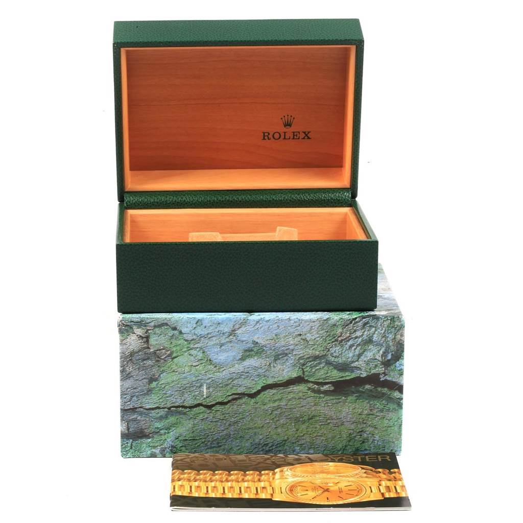 The image shows an open green Rolex box for the Submariner model, with its outer box and a pamphlet.