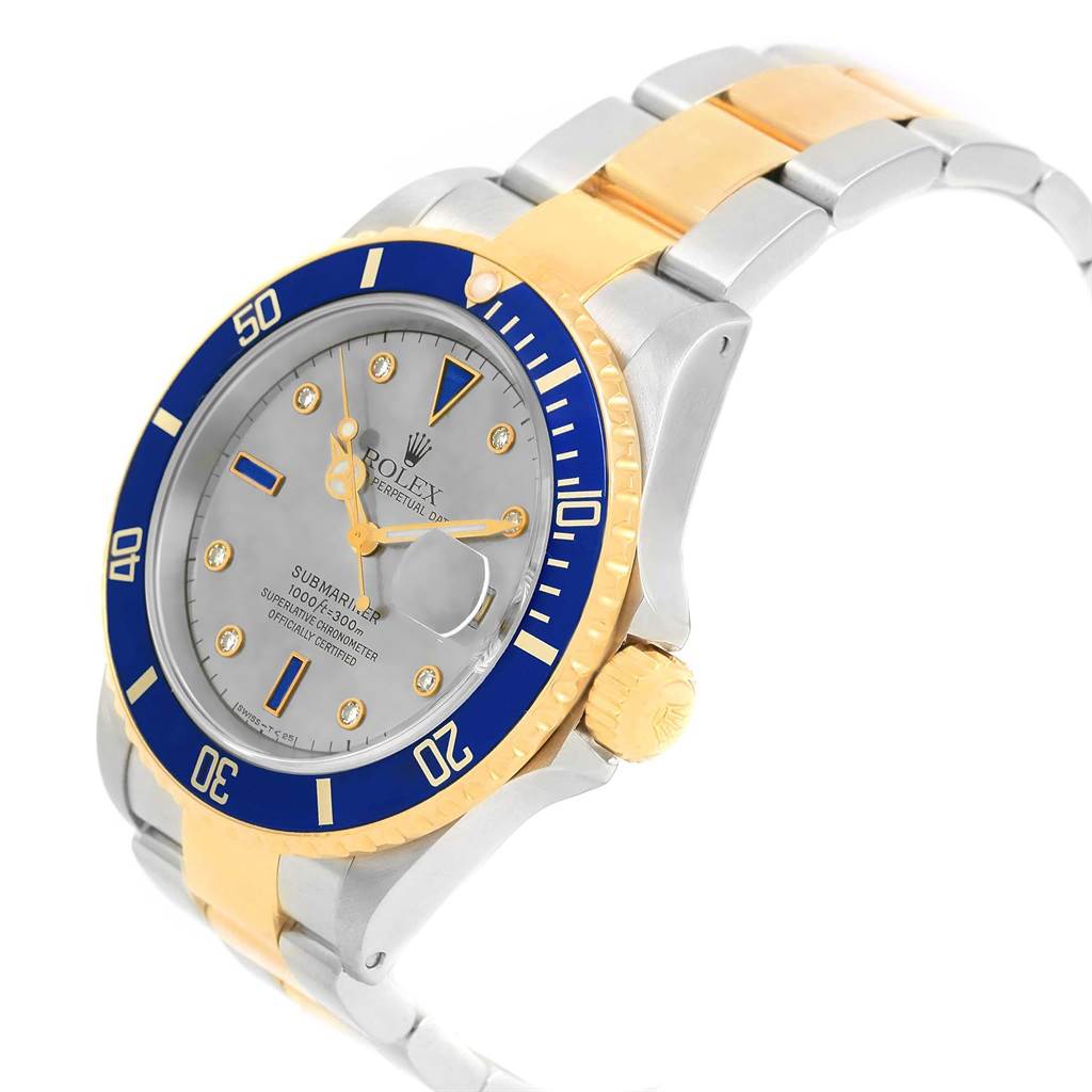This image shows a slanted view of the Rolex Submariner 16613 Men's Steel and Gold (two tone) Grey Dial 16613 Men's Steel and Gold (two tone) Grey Dial watch, highlighting the bezel, dial, and bracelet with gold accents.