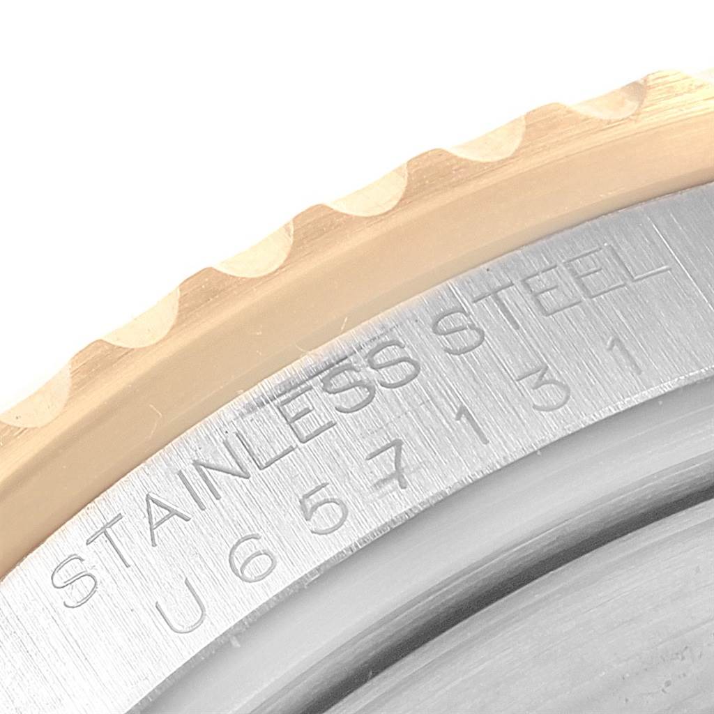 This close-up image shows the engraved side of the stainless steel bezel of a Rolex Submariner 16613 Men's Steel and Gold (two tone) Grey Dial 16613 Men's Steel and Gold (two tone) Grey Dial watch.