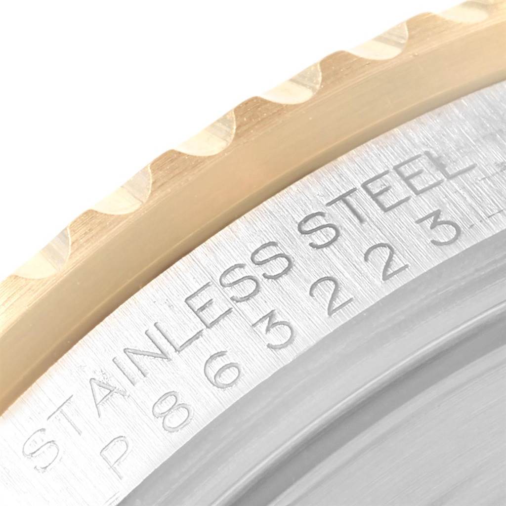 The image shows a close-up of the bezel and part of the case back of a Rolex Submariner 16613 Men's Steel and Gold (two tone) Blue Dial 16613 Men's Steel and Gold (two tone) Blue Dial watch.