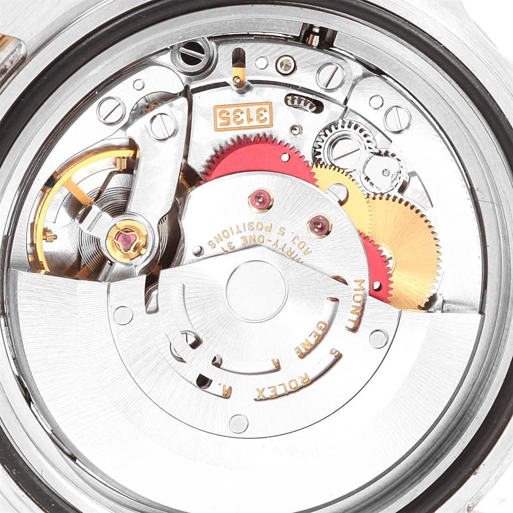 This image shows the internal mechanism of the Rolex Submariner 16613 Men's Steel and Gold (two tone) Blue Dial 16613 Men's Steel and Gold (two tone) Blue Dial watch, including gears and the balance wheel.