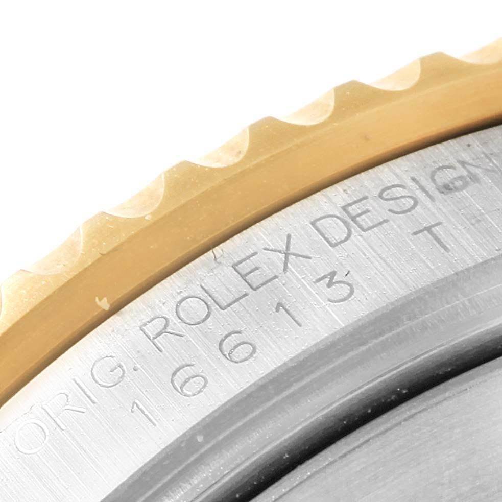 Close-up of the bezel and casing of a Rolex Submariner 3 Men's Steel and Gold (two tone) Blue Dial 3 Men's Steel and Gold (two tone) Blue Dial, showing the model number engraved on the side.