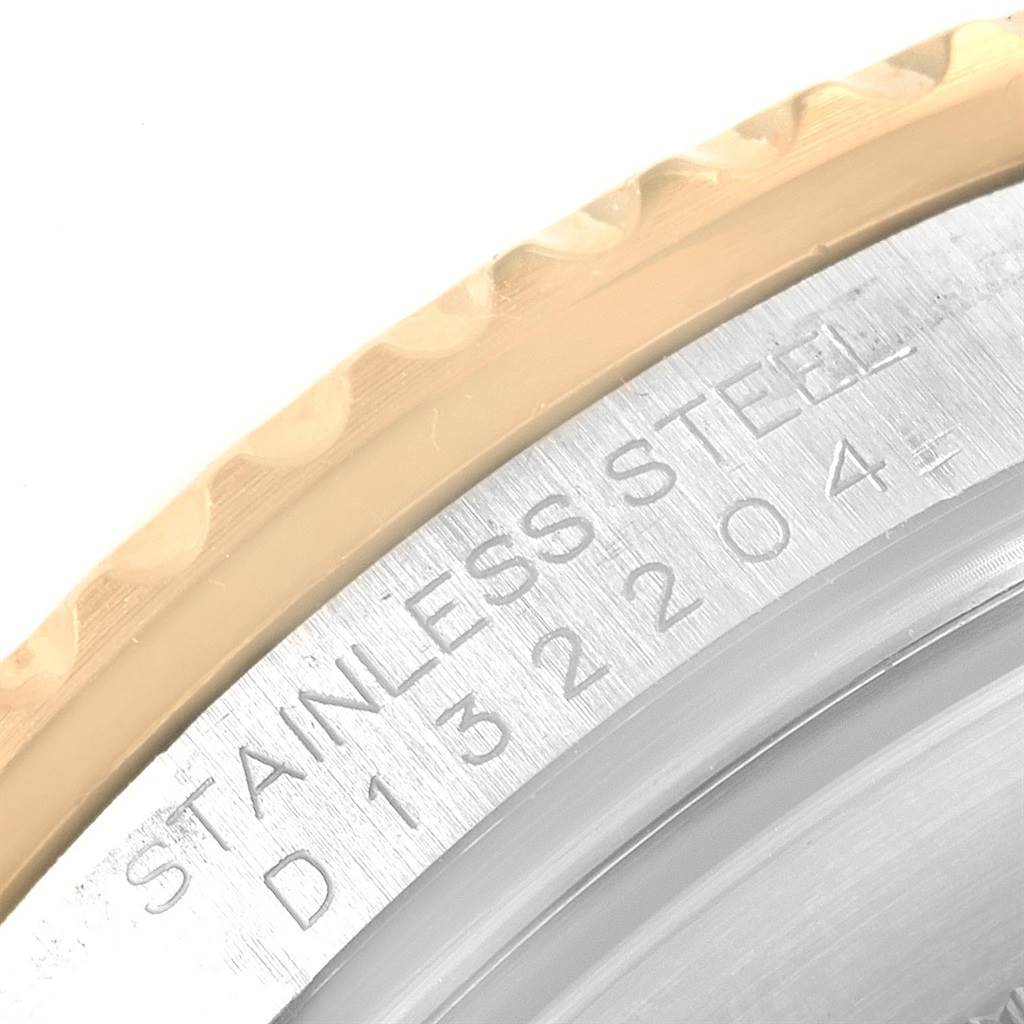 This close-up image shows a partial side view of the stainless steel bezel and edge of a Rolex Submariner 3 Men's Steel and Gold (two tone) Blue Dial 3 Men's Steel and Gold (two tone) Blue Dial watch.