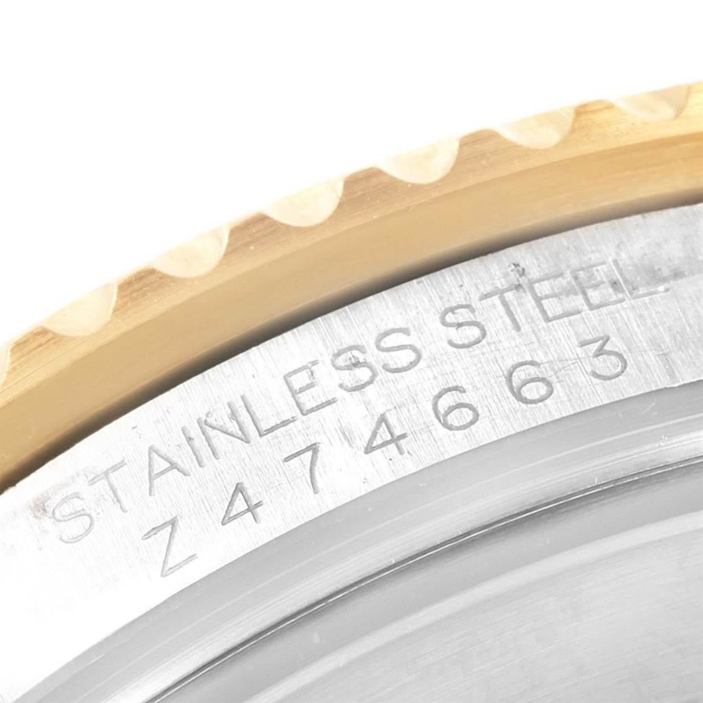 This close-up image shows the stainless steel case and engraved serial number of a Rolex Submariner 16613 Men's Steel and Gold (two tone) Black Dial 16613 Men's Steel and Gold (two tone) Black Dial watch.