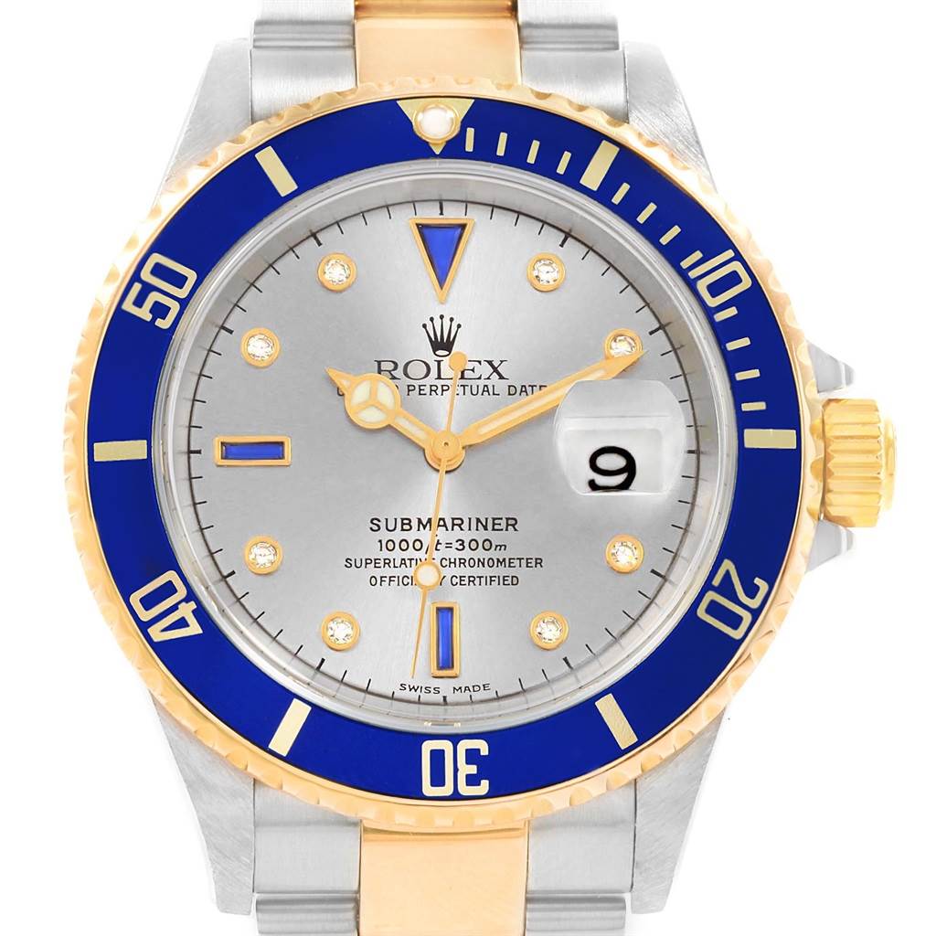 The image shows a front view of a Rolex Submariner 16613 Men's Steel and Gold (two tone) Grey Dial 16613 Men's Steel and Gold (two tone) Grey Dial watch with a blue bezel, gold accents, and a silver dial.
