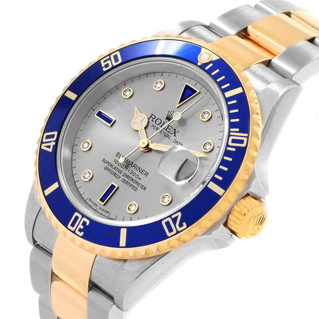 The image shows a close-up angle of the Rolex Submariner 16613 Men's Steel and Gold (two tone) Grey Dial 16613 Men's Steel and Gold (two tone) Grey Dial watch, highlighting the dial, bezel, crown, and bracelet.