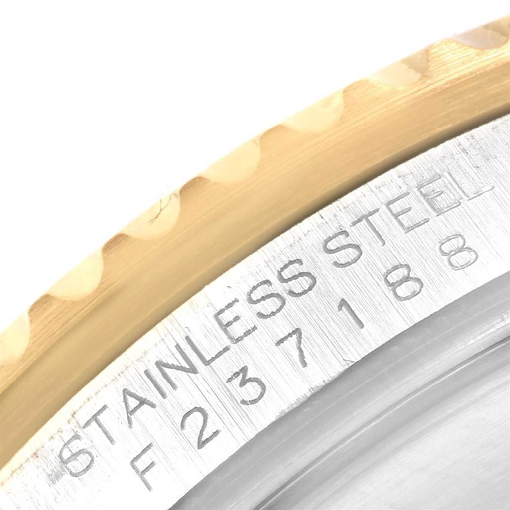 This image shows a close-up of the stainless steel case back and part of the bezel of the Rolex Submariner 16613 Men's Steel and Gold (two tone) Grey Dial 16613 Men's Steel and Gold (two tone) Grey Dial watch.