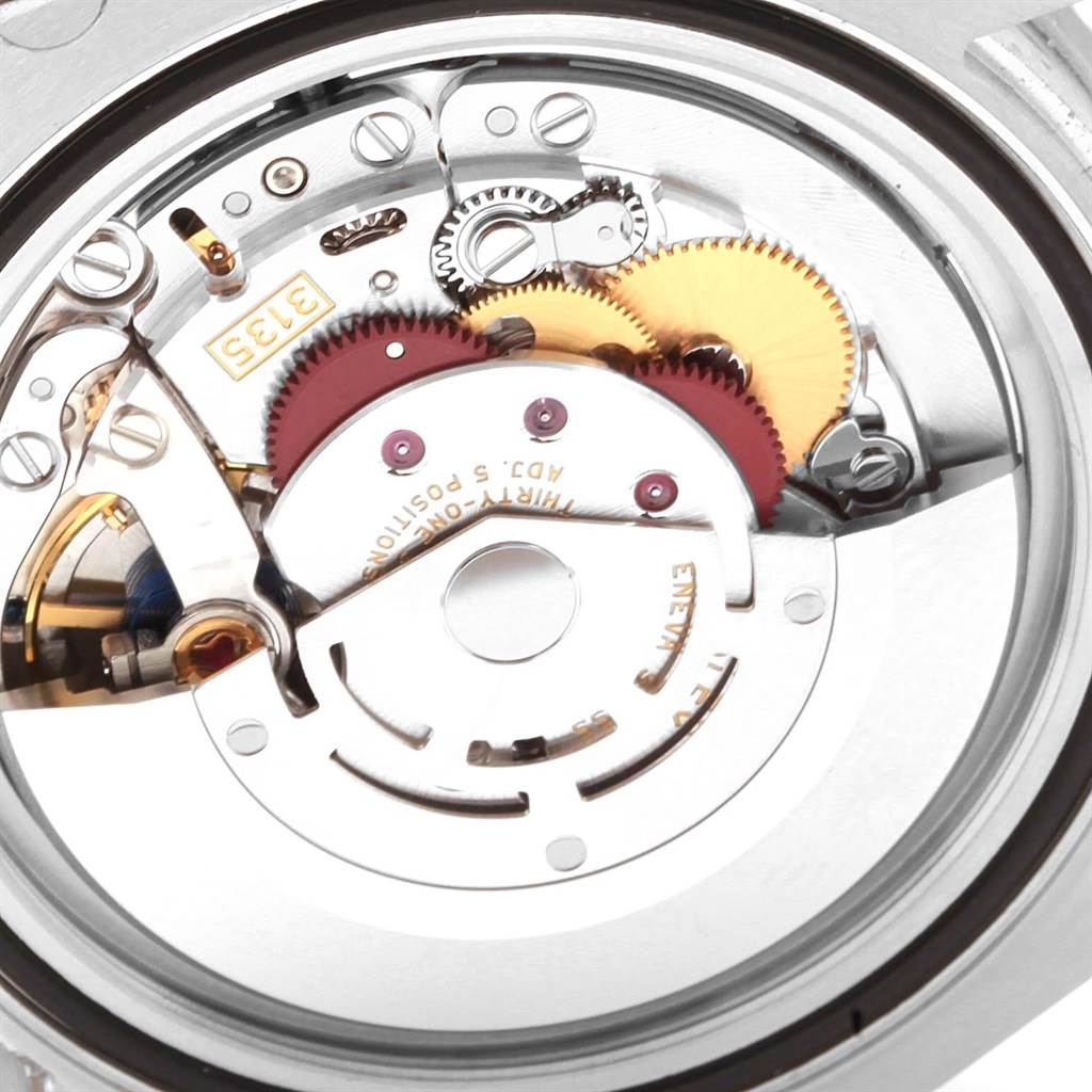 This is a close-up view of the movement mechanism of a Rolex Submariner 116610LV Men's Stainless Steel Green Dial 116610LV Men's Stainless Steel Green Dial watch, showing its intricate gears and components.