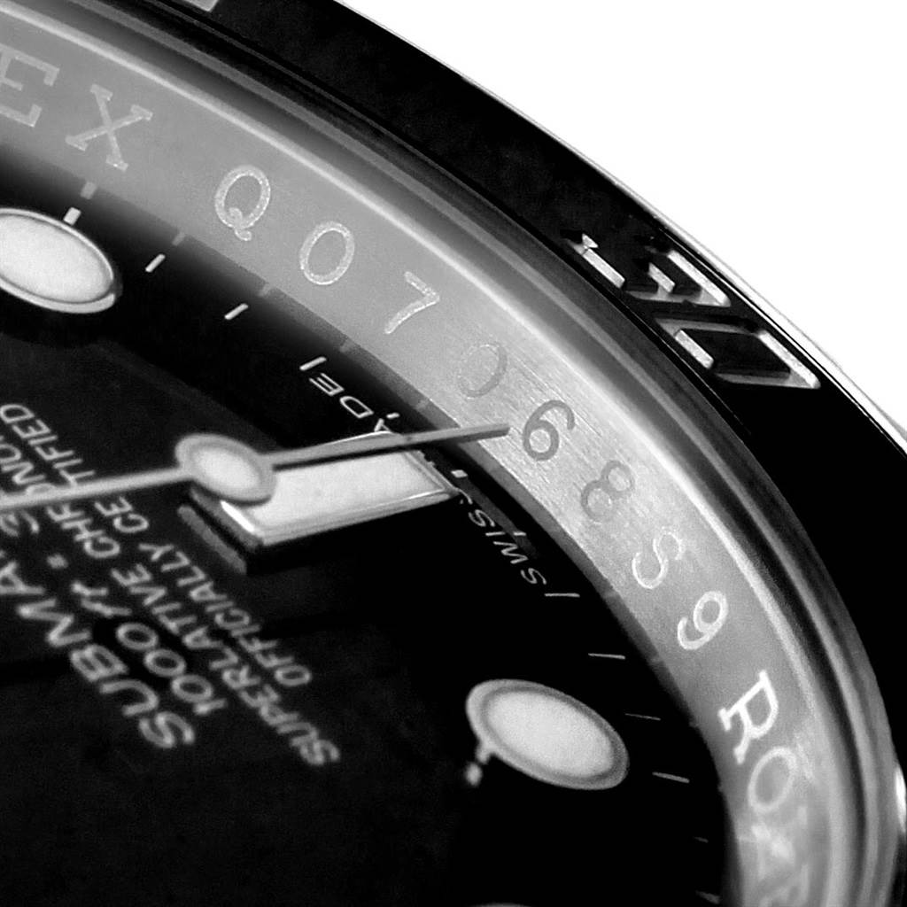 The image shows a close-up of the dial, minute hand, and part of the rehaut of a Rolex Submariner 114060 Men's Stainless Steel Black Dial 114060 Men's Stainless Steel Black Dial watch.