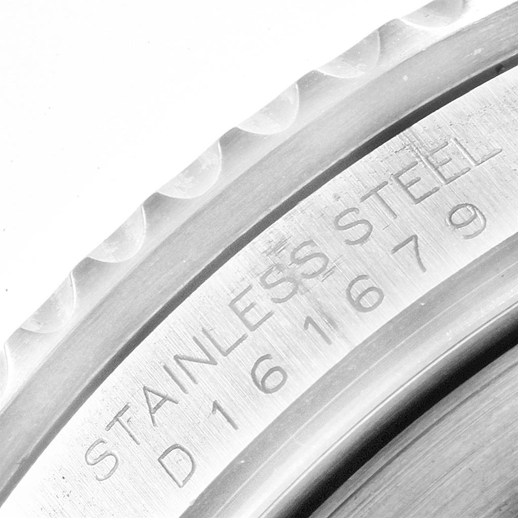 This image shows a close-up of the engraved stainless steel caseback and part of the bezel of the Rolex Submariner 16610LV Men
s Stainless Steel Black Dial 16610LV Men
s Stainless Steel Black Dial watch.