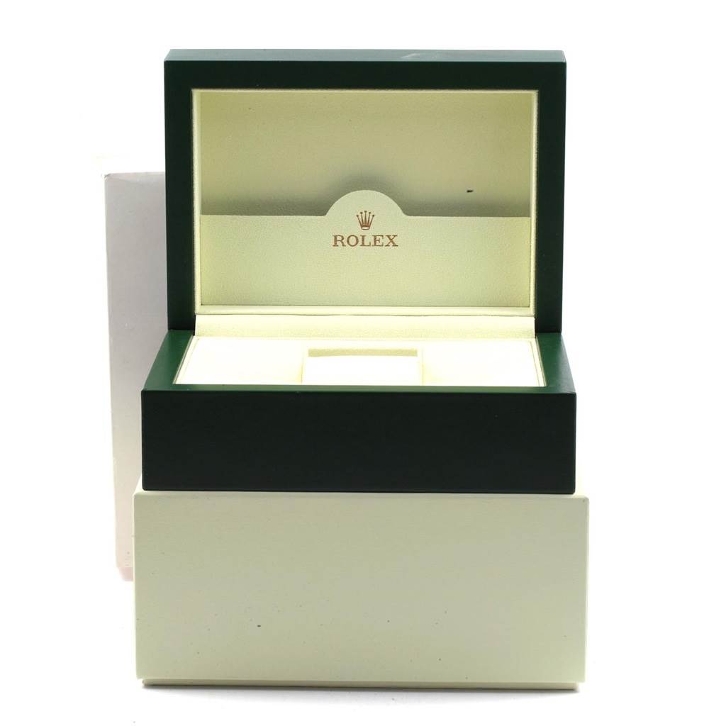 The image shows an open green Rolex Submariner 16610LV Men
s Stainless Steel Black Dial 16610LV Men
s Stainless Steel Black Dial watch box, showcasing the inner padding and logo.