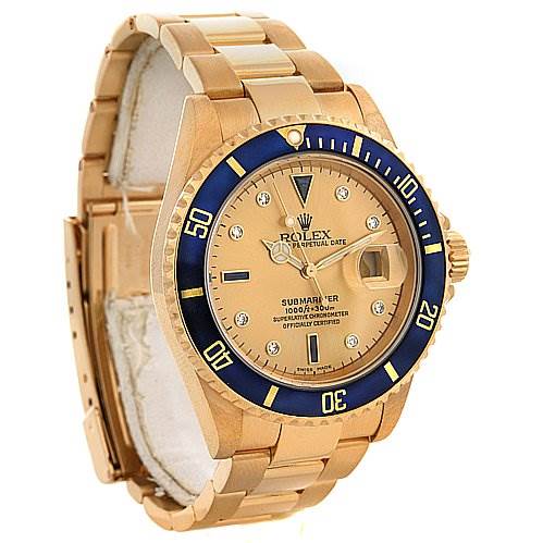 This image shows a Rolex Submariner 16618 Men's Yellow Gold Champagne Dial 16618 Men's Yellow Gold Champagne Dial watch at an angled perspective, highlighting the blue bezel, gold case, bracelet, and dial.
