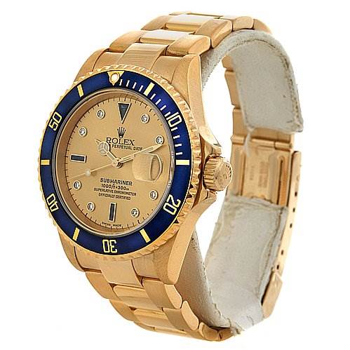 The image shows a side-angle view of a Rolex Submariner 16618 Men's Yellow Gold Champagne Dial 16618 Men's Yellow Gold Champagne Dial watch, highlighting its golden bracelet, blue bezel, and face detailing.