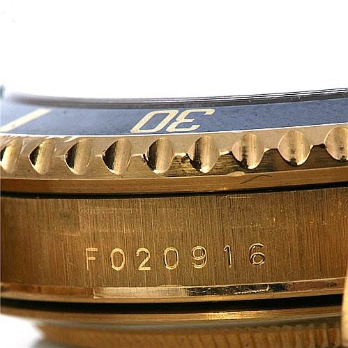 This image shows a close-up of the bezel and case side of a Rolex Submariner 16618 Men's Yellow Gold Champagne Dial 16618 Men's Yellow Gold Champagne Dial watch, with the serial number visible.