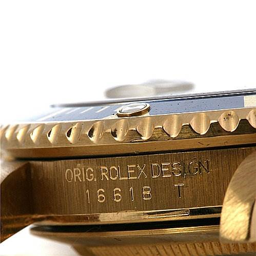 This close-up shows the side of the Rolex Submariner 16618 Men's Yellow Gold Champagne Dial 16618 Men's Yellow Gold Champagne Dial watch case, highlighting the bezel and model number 16618 T engraving.