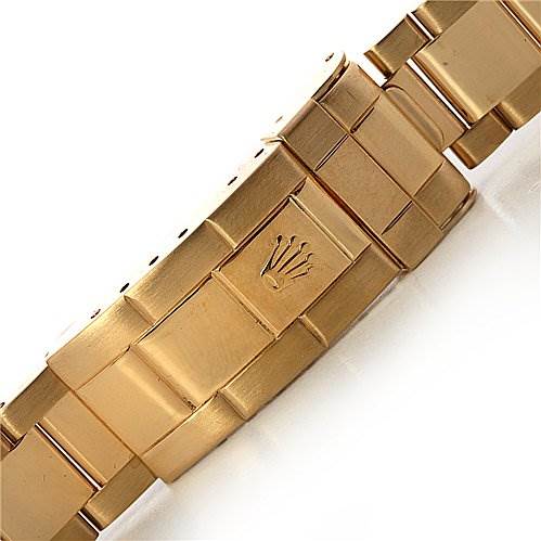The image shows the clasp and part of the bracelet of a Rolex Submariner 16618 Men's Yellow Gold Champagne Dial 16618 Men's Yellow Gold Champagne Dial watch in gold, featuring the Rolex crown logo.