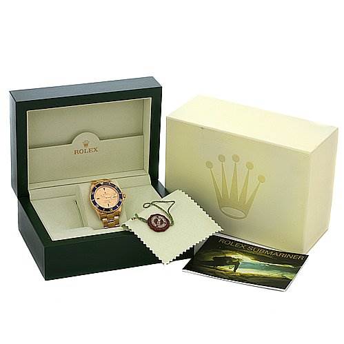 The image shows a Rolex Submariner 16618 Men's Yellow Gold Champagne Dial 16618 Men's Yellow Gold Champagne Dial watch at an angle inside its open box, with the outer box, cloth, tag, and manual.