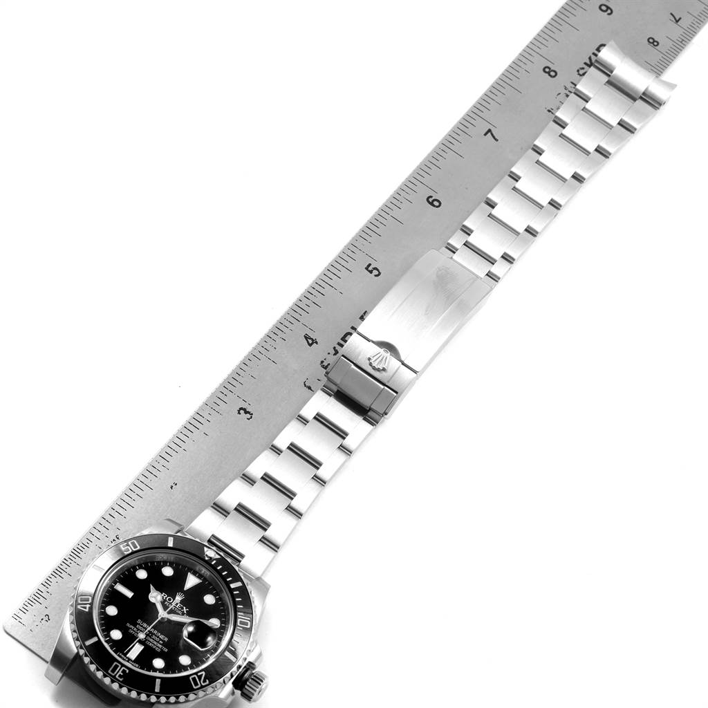 The image shows a Rolex Submariner 116610 Men's Stainless Steel Black Dial 116610 Men's Stainless Steel Black Dial watch lying flat, with a ruler beside it to measure the length of the stainless steel bracelet.