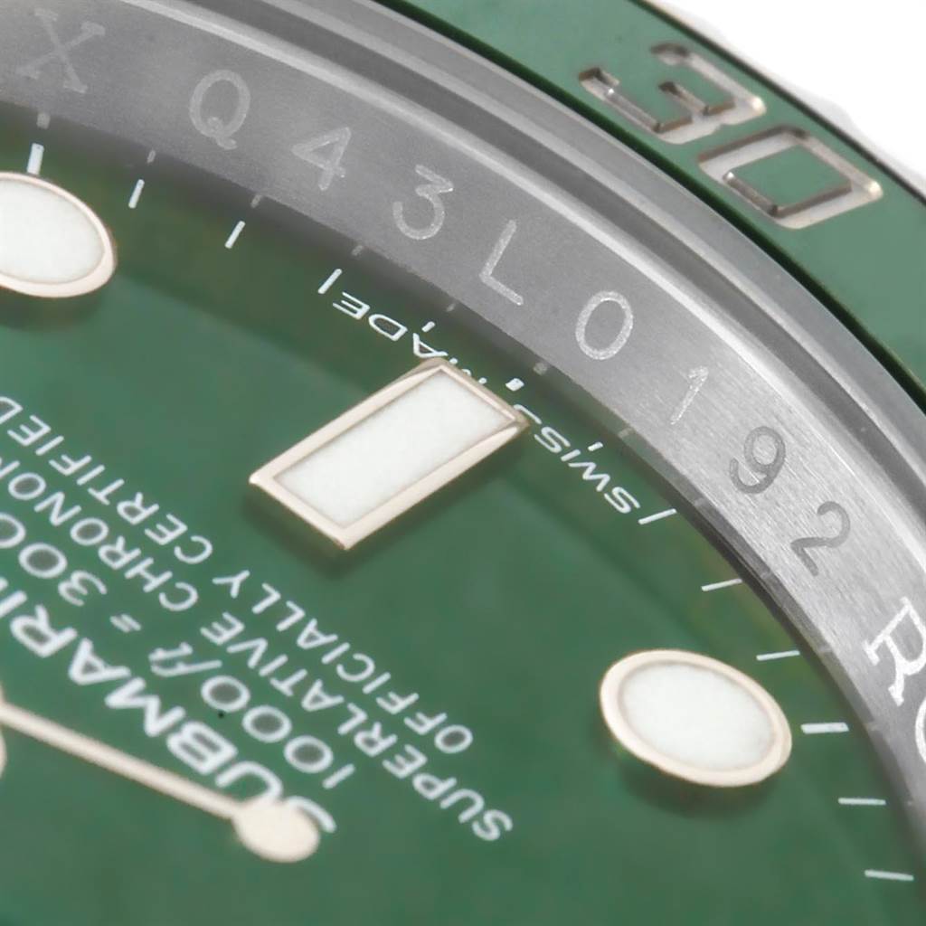 This close-up angle of a Rolex Submariner 116610LV Men's Stainless Steel Green Dial 116610LV Men's Stainless Steel Green Dial watch showcases the green dial and part of the bezel with numeric engravings.