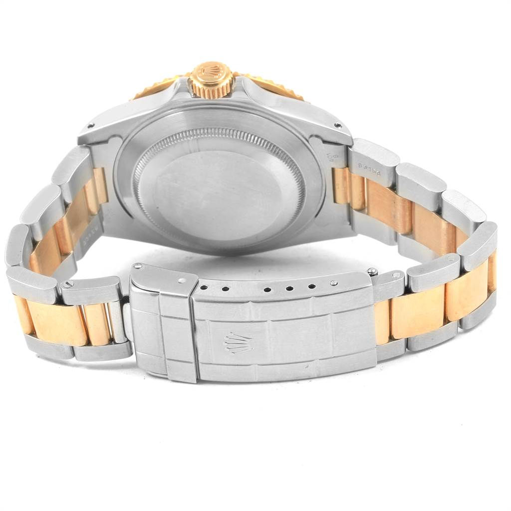 The image shows the back and clasp of a Rolex Submariner 16613 Men's Steel and Gold (two tone) Black Dial 16613 Men's Steel and Gold (two tone) Black Dial watch, highlighting the two-tone bracelet and case back.