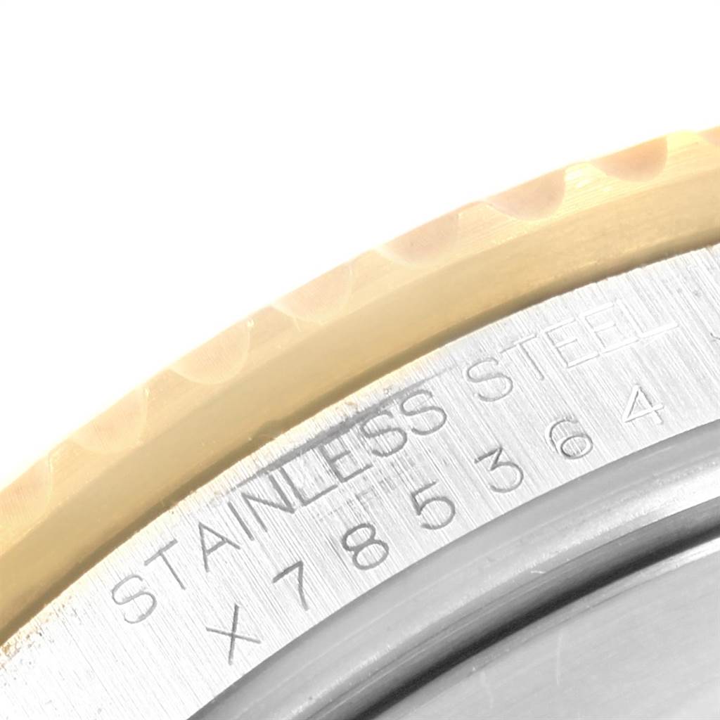 This image shows a close-up of the caseback engraving and outer edge of the bezel of the Rolex Submariner 16613 Men's Steel and Gold (two tone) Black Dial 16613 Men's Steel and Gold (two tone) Black Dial watch.