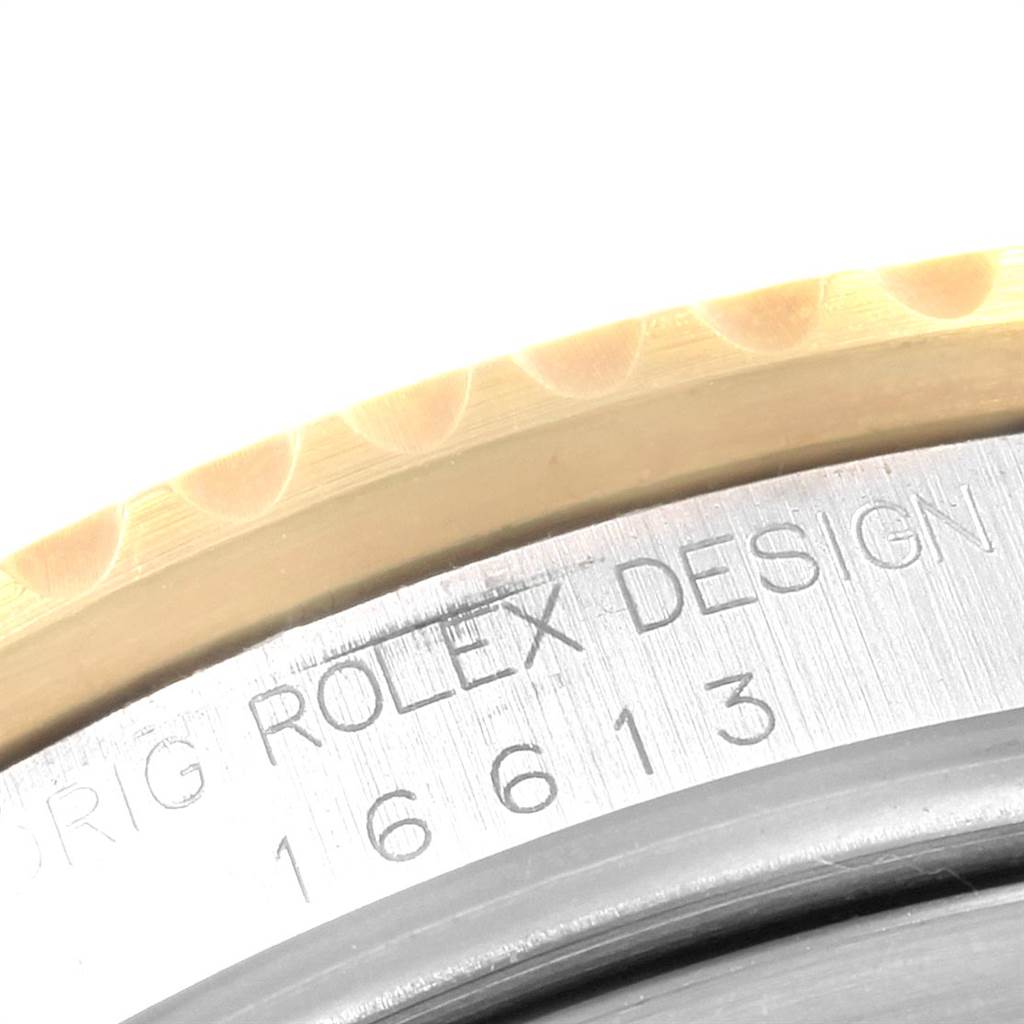 This image shows a close-up of the bezel and case with the model number of a Rolex Submariner 16613 Men's Steel and Gold (two tone) Black Dial 16613 Men's Steel and Gold (two tone) Black Dial watch.